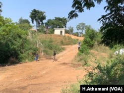 A man looks on at a fence being dug around the Isimba Dam in Kayunga to keep residents away from the shores of the Victoria Nile River in Kayunga district, Uganda.