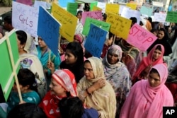 FILE - Pakistani women observe the International Day for the Elimination of Violence against Women, in Lahore, Pakistan, Nov. 25, 2015.