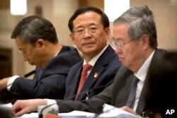 FILE - Liu Shiyu, chairman of the China Securities Regulatory Commission, attends a discussion group meeting held on the sidelines of China's 19th Party Congress at the Great Hall of the People in Beijing, Oct. 19, 2017.