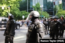 Armed police officers fill downtown Portland, near City Hall, during rival “anti-hate” and “free speech” rallies, June 4, 2017.