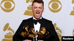 Sam Smith poses with his awards including one for Best New Artist.