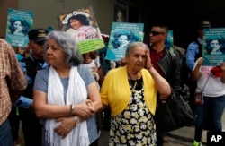 Honduran human rights defender Bertha Oliva, left, stands arm in arm with Austra Bertha Flores, the mother of slain environmental activist and Goldman Environmental Prize winner Berta Caceres, during a protest demanding justice for Caceres, outside the Prosector's Office in Tegucigalpa, Honduras, March 2, 2018.