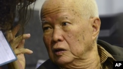 In this photo released by the Extraordinary Chambers in the Courts of Cambodia, Khieu Samphan, a former head of state for the Khmer Rouge, gestures as testimony is given during his trial at the U.N.-backed war crimes tribunal in Phnom Penh, file photo. 