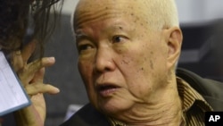 In this photo released by the Extraordinary Chambers in the Courts of Cambodia, Khieu Samphan, a former head of state for the Khmer Rouge, gestures as testimony is given during his trial at the U.N.-backed war crimes tribunal in Phnom Penh, file photo. 