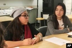 FILE - Mexican students Yatziri Tovar, left, and Roxanna Herrera, discuss their travel plans at City College of New York, Dec. 1, 2016.