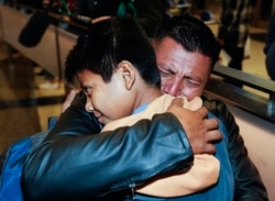 FILE - David Xol-Cholom, of Guatemala, hugs his son Byron Xol-Cholom at Los Angeles International Airport as they reunite after being separated during the Trump administration's wide-scale separation of immigrant families, in Los Angeles, Jan. 22, 2020.