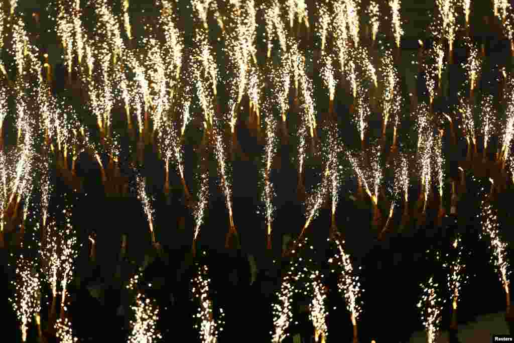 Students hold fireworks as they perform during the opening ceremony of 27th SEA Games in Naypyitaw. Myanmar is hosting the SEA Games for the first time in over 40 years.