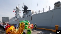 A dragon dance welcomes Wuhu, a Type 054A guided missile frigate from the Chinese Naval Task Group, as it docks at Manila's South Harbor for a four-day port call, Jan. 17, 2019 in Manila, Philippines.