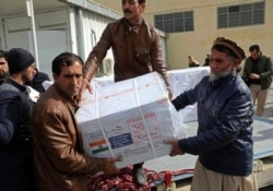 Afghan health ministry workers unloads boxes of the first shipment of 500,000 doses of the AstraZeneca coronavirus vaccine made by Serum Institute of India, donated by the Indian government to Afghanistan.