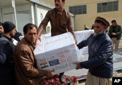 Afghan health ministry workers unloads boxes of the first shipment of 500,000 doses of the AstraZeneca coronavirus vaccine made by Serum Institute of India, donated by the Indian government to Afghanistan.
