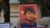 A demonstrator holds up a sign outside the Chinese Embassy as people protest against the military coup and demand the release of elected leader Aung San Suu Kyi, in Yangon, Myanmar, February 11, 2021. REUTERS/Stringer