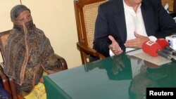 FILE - Pakistani Christian woman Asia Bibi is seen after a meeting with the governor of the Punjab Province at a jail in Sheikhupura, Pakistan.