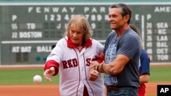 FILE - About to turn 100-years-old, Babe Ruth's daughter Julia Ruth Stevens throws out the ceremonial first pitch with help from her son Tom before a baseball game between the Boston Red Sox and the Tampa Bay Rays at Fenway Park in Boston, Saturday, July 