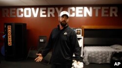 In this April 12, 2019, photo, Washington Redskins head athletic trainer Larry Hess leads a tour of a recovery room at the team's NFL football training facility in Ashburn, Va. (AP Photo/Patrick Semansky)