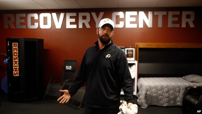 In this April 12, 2019, photo, Washington Redskins head athletic trainer Larry Hess leads a tour of a recovery room at the team's NFL football training facility in Ashburn, Va. (AP Photo/Patrick Semansky)