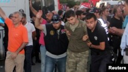 Soldiers suspected of being involved in the coup attempt are escorted by policemen as they arrive at a courthouse in the resort town of Marmaris, Turkey, July 17, 2016. 