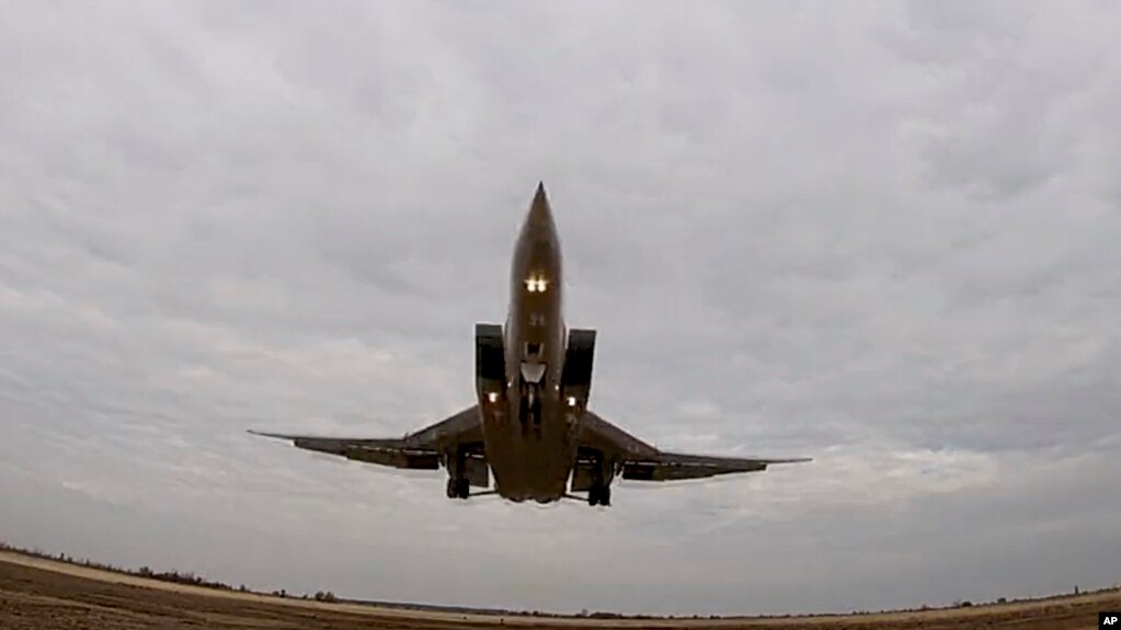 FILE - In this handout photo taken from video released by Russian Defense Ministry Press Service Nov. 10, 2021, a long-range Tu-22M3 bomber of the Russian Aerospace Forces takes-off to patrol the airspace of Belarus.