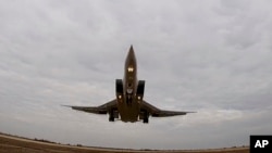 FILE - In this handout photo taken from video released by Russian Defense Ministry Press Service Nov. 10, 2021, a long-range Tu-22M3 bomber of the Russian Aerospace Forces takes-off to patrol the airspace of Belarus.