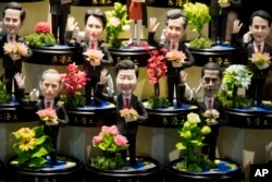 Clay figures, showing U.S. President Barack Obama, Chinese President Xi Jinping and Russian President Vladimir Putin amongst other state leaders expected to attend the G20 summit are displayed at a shop in Hangzhou in eastern China's Zhejiang province.