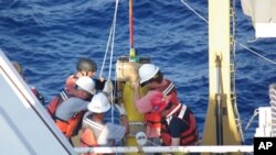 Personnel aboard the NOAA ship, Thomas Jefferson, prepare to launch a glider that belongs to the Naval Oceanographic Office as part of a Gulf of Mexico Loop Current research cruise.