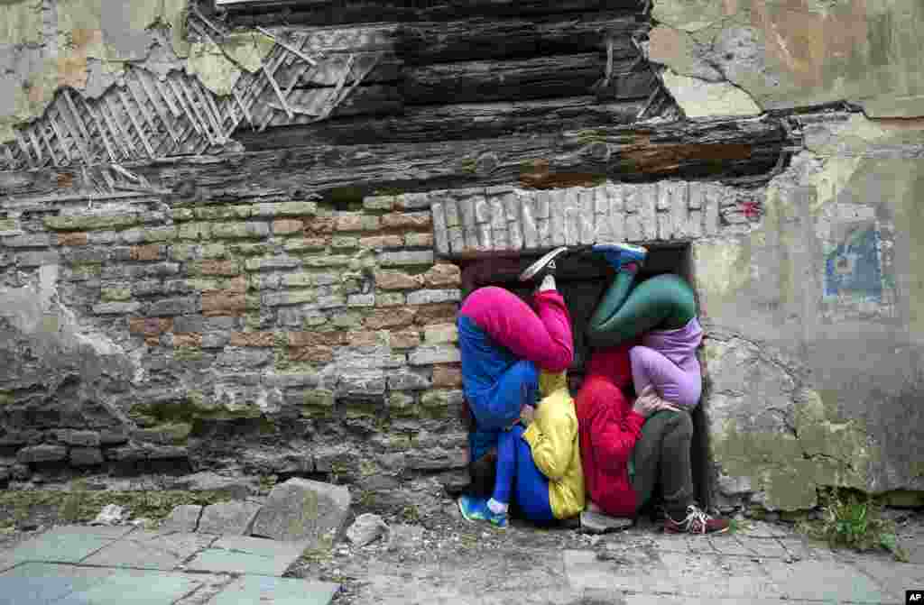 Performers present the Bodies in Urban Spaces project from Austrian artist Willi Dorner, in Vilnius, Lithuania, April 28, 2018.