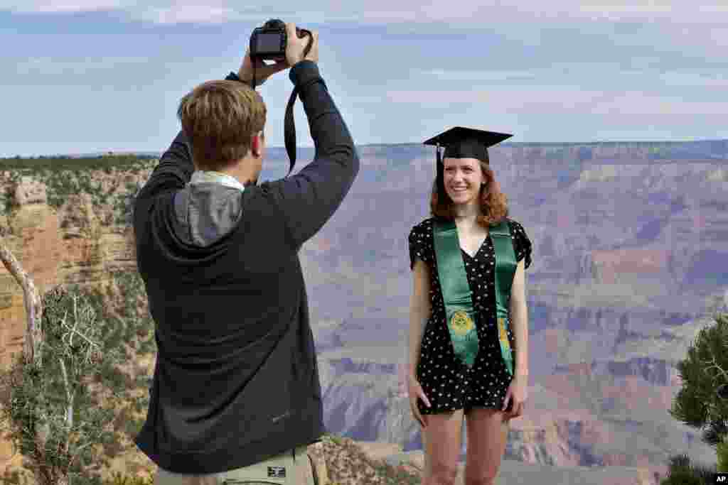 Andrew Fink takes a picture of recent Baylor University graduate Cady Malachowski at the Grand Canyon in Arizona. Grand Canyon National Park partly reopened Friday. Some observers criticized the decision, saying the action could lead to a greater spread of the new coronavirus.&nbsp; &nbsp;