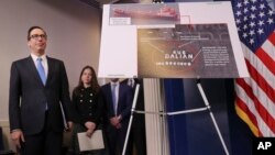 Treasury Secretary Steven Mnuchin waits to take the podium before starting a briefing at the White House in Washington, Feb. 23, 2018. The Trump administration announced new sanctions on more than 50 vessels, shipping companies and trade businesses in its latest bid to pressure North Korea over its nuclear program.