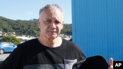 In this Aug. 31, 2019, photo, gun owner Phillip Fee holds his gun bag outside a temporary gun collection venue in Porirua, near Wellington, New Zealand. (AP Photo/Nick Perry)