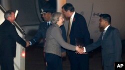 India Britain: Britain's Prime Minister Theresa May, centre, is welcomed by an official upon her arrival at the Palam airport in New Delhi, India, Sunday, Nov. 6, 2016. 