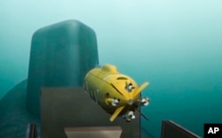 In this video grab provided by RU-RTR Russian television via AP television on March 1, 2018, a computer simulation shows a Russian nuclear-powered underwater drone being released by a submarine.