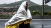A man from Eritrea walks along the road after leaving a Red Cross Caritas camp set up for migrants in the Italian border town of Ventimiglia, Italy, Oct. 13, 2016. (R. Shryock/VOA)