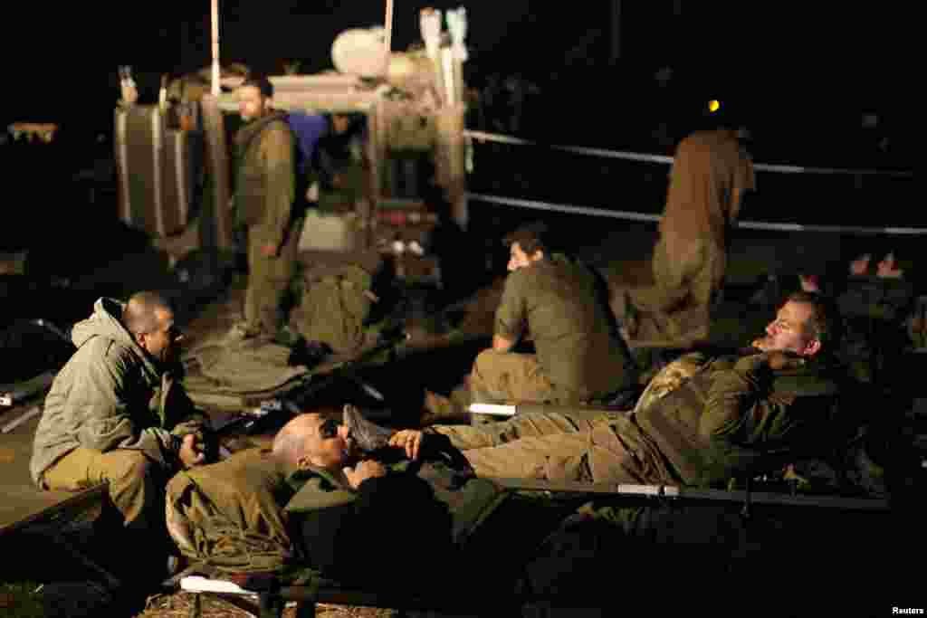 Israeli soldiers rest at a staging area outside the northern Gaza Strip, Nov. 21, 2012.