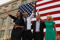 U.S. President Barack Obama, first lady Michelle Obama, U.S. Vice President Joseph Biden, and his wife, Dr. Jill Biden, all wave after Obama speaks at a campaign event at the University of Iowa's Jessup Hall Lawn in Iowa City, Iowa, September 7, 2012.