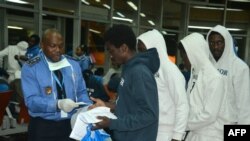 FILE - Cameroonian migrants receive registration forms upon their arrival after spending several months in Libya, at the Yaounde International Airport in Cameroon, Nov.r 22, 2017.