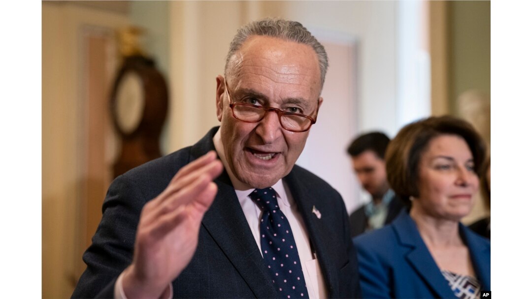 Senate Minority Leader Chuck Schumer, D-N.Y., joined at right by Sen. Amy Klobuchar, D-Minn., speaks to reporters at the Capitol in Washington, April 9, 2019.