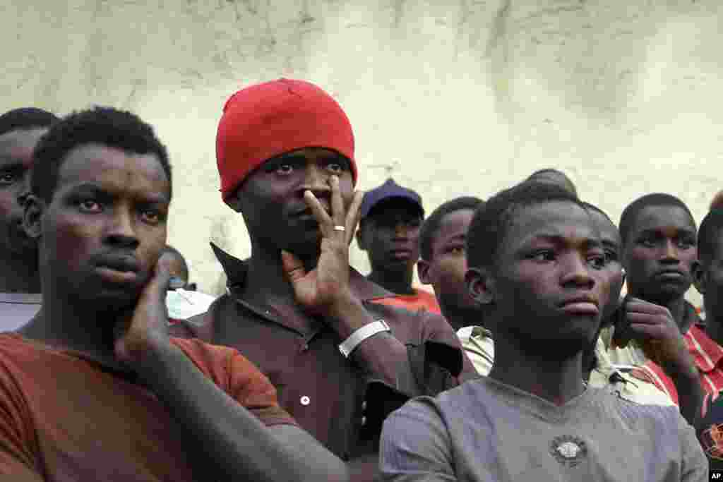 People watch as emergency officials search for survivors and victims after a building still under construction collapsed in Mpape district in Nigeria's capital Abuja August 19, 2011. It was not immediately known how many casualties there were, but at leas