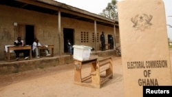 FILE - A sign for Ghana's Electoral Commission is seen at a polling station in Accra during a previous poll.