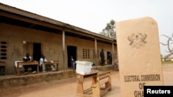 FILE - A sign for Ghana's electoral commission is seen at a polling station in Accra during a previous election.