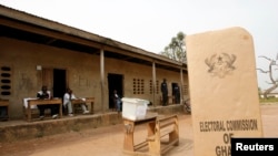 FILE - A sign for Ghana's Electoral Commission is seen at a polling station in Accra during a previous poll.