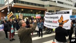 Demonstrators block traffic in front of the hotel where U.S. Attorney General Jeff Sessions was speaking to the California Peace Officers Association meeting, Wednesday, March 7, 2018, in Sacramento, Calif. California Gov. Jerry Brown denounced Sessions for coming to the state to speak about a lawsuit targeting policies that limit cooperation with federal immigration authorities, saying Wednesday it was unprecedented for him to "act more like Fox News than a law enforcement officer."