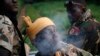 FILE - A Seleka fighter smokes during a patrol, close to the border of the Democratic Republic of Congo June 10, 2014.