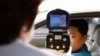 FILE - A South Korean official, left, uses a thermal camera to checks the body temperature of a driver as a precaution against Middle East Respiratory Syndrome (MERS) after he returned from Kaesong, North Korea, near Panmunjom, South Korea, June 13, 2015.