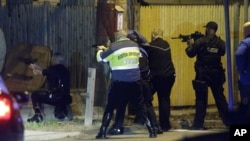 Police officers aim their weapons in Watertown, Massachusetts, April 19, 2013.