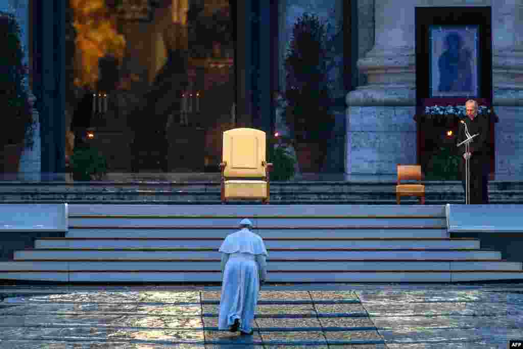 Pope Francis walks toward the platform to lead a moment of prayer on the sagrato of St Peter&#39;s Basilica, at the Vatican.