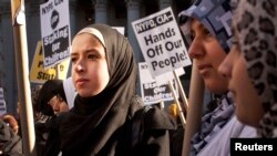 FILE - Muslim women protest against alleged heavy-handedness on the part of the New York Police Department.