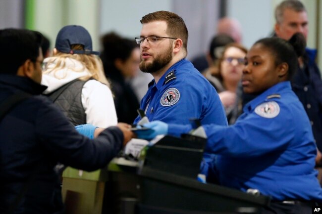 Transportation Security Administration officers work at a checkpoint at Logan International Airport in Boston, Jan. 5, 2019.