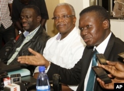 FILE - Uganda opposition leaders, from left to right: Forum for Democratic Change, Dr. Kizza Besigye, former Prime Minister Amama Mbabazi and Democratic Party President Norber Mao meeting at the Democratic Alliance office in Kampala, Sept. 18, 2015.