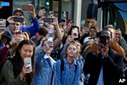 University of Pittsburgh students line the sidewalk across the street from the University of Pittsburgh's Presbyterian Hospital as President Donald Trump's motorcade arrives at the University of Pittsburgh's Presbyterian Hospital in Pittsburgh, Oct. 30, 2018.