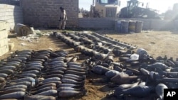 FILE - Weapons and explosives confiscated by Iraqi security forces from Islamic State militants are on display at an Iraqi army base as security forces advance their position in northern Ramadi,115 kilometers west of Baghdad, Iraq.