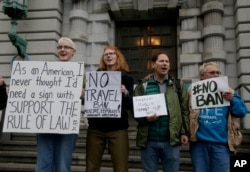 FILE - Kay Aull, from left, holds a sign and chants with Beth Kohn, Paul Paz y Mino and Karen Shore outside of the 9th U.S. Circuit Court of Appeals in San Francisco, Calif.